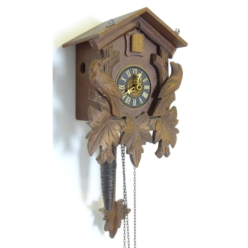 1186 - A mid - late 20thC cuckoo clock, with  ' Regula 'movement and 2 cast pine cone fomred weights. Retai... 