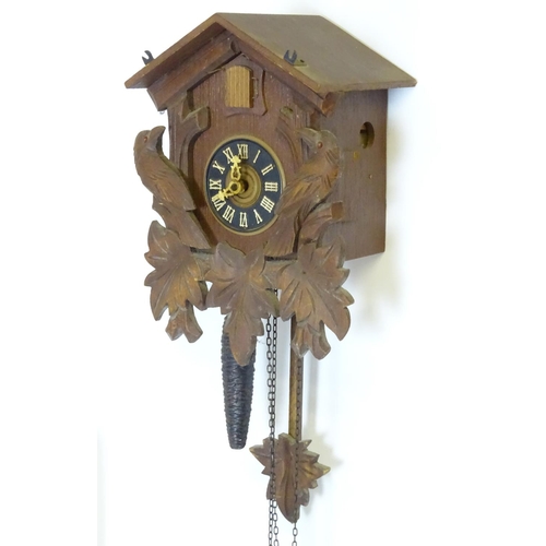 1186 - A mid - late 20thC cuckoo clock, with  ' Regula 'movement and 2 cast pine cone fomred weights. Retai... 