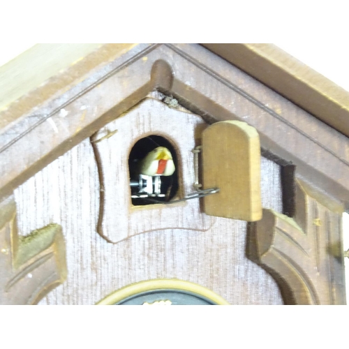 1186 - A mid - late 20thC cuckoo clock, with  ' Regula 'movement and 2 cast pine cone fomred weights. Retai... 