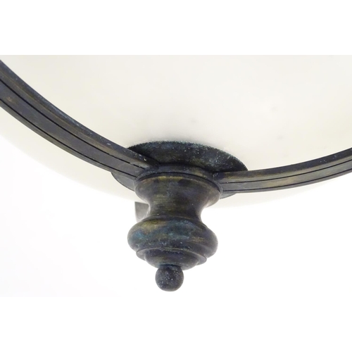 1202 - A pair of ceiling lights with frosted glass domed shades and metal strap work 18