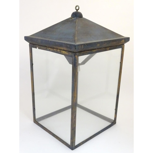 1205 - An early 20thC  large hanging light of lantern form with four glass panels. The whole Approx 32