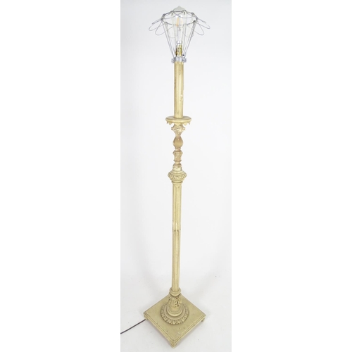 1221 - A carved and painted wooded standard lamp with reeded column on a squared base. Approx 60