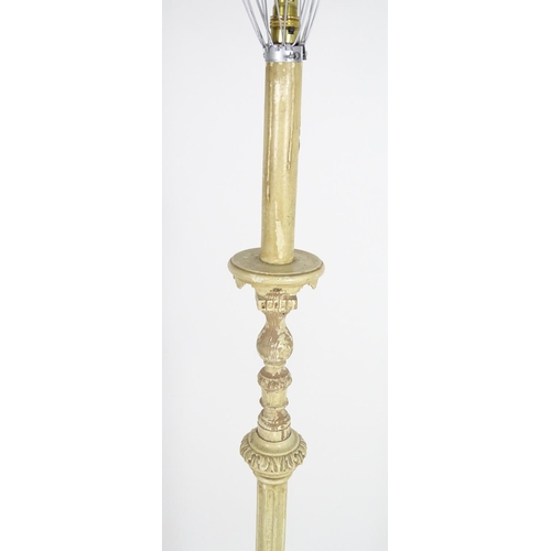 1221 - A carved and painted wooded standard lamp with reeded column on a squared base. Approx 60