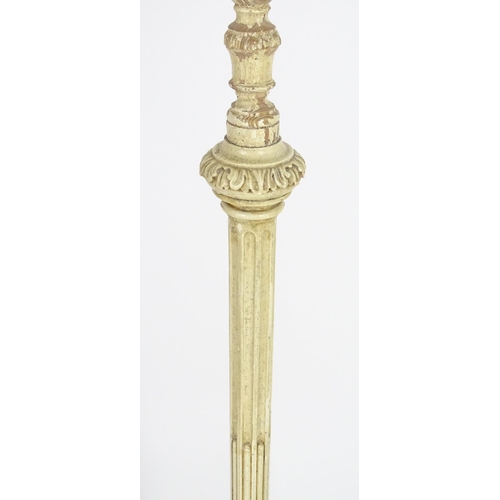 1221 - A carved and painted wooded standard lamp with reeded column on a squared base. Approx 60