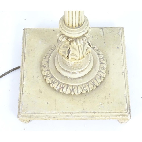 1221 - A carved and painted wooded standard lamp with reeded column on a squared base. Approx 60