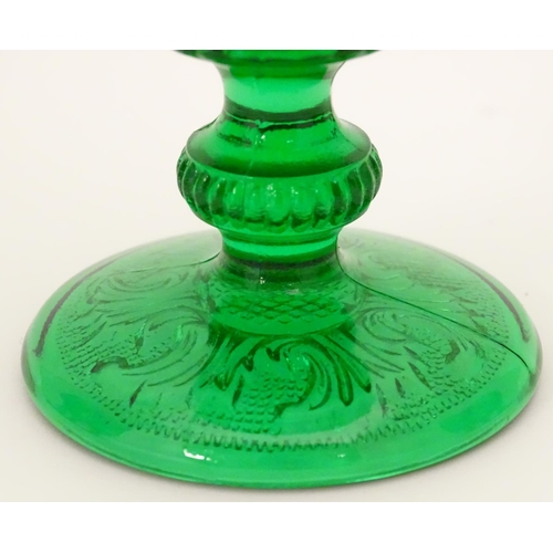 160 - A set of 7 vintage green glass  pedestal glasses with moulded decoration . Approx 4