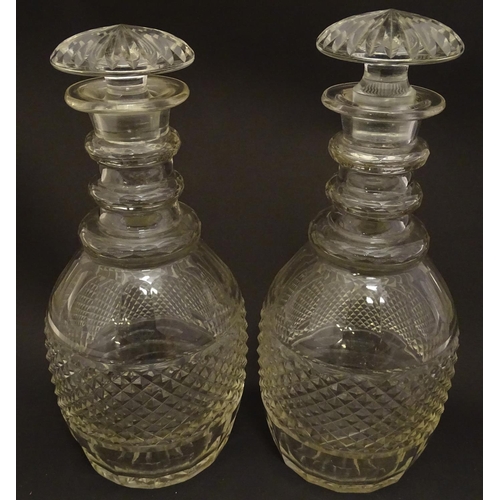 165 - A pair of three ring cut glass decanter with hobnail banding. Approx 11 1/4