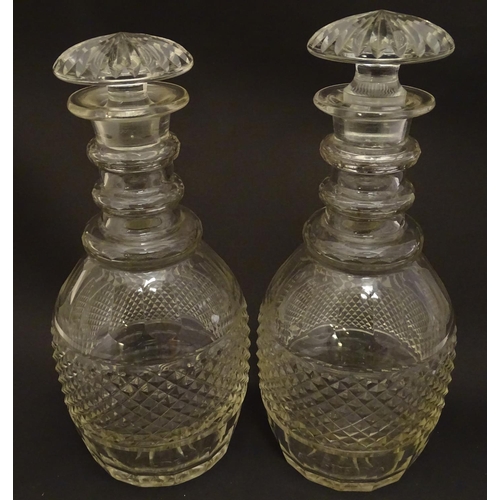 165 - A pair of three ring cut glass decanter with hobnail banding. Approx 11 1/4