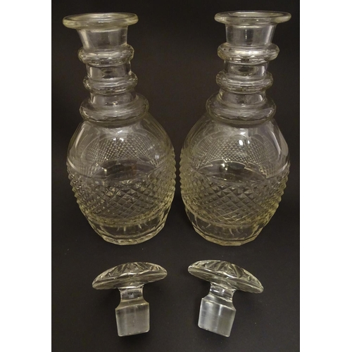 165 - A pair of three ring cut glass decanter with hobnail banding. Approx 11 1/4