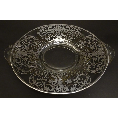 172 - A glass twin handled fruit dish / plate with silvered overlay decoration Approx. 13