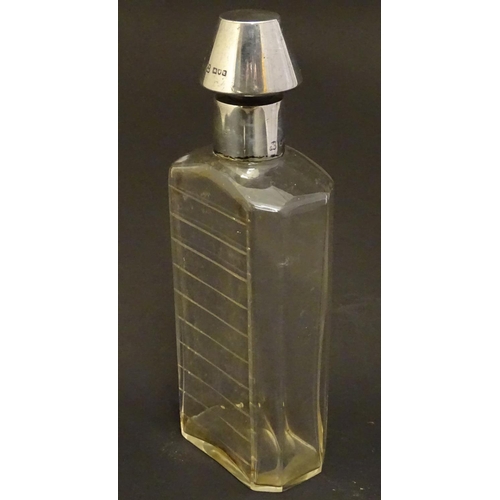 178 - A glass medicine flask / decanter with cut horizontal measure marks to back. With silver mount and s... 