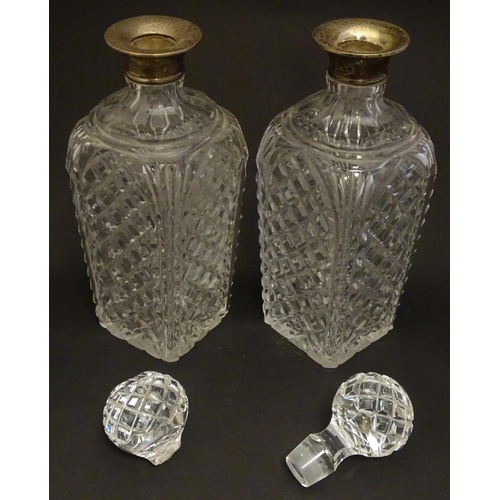 179 - Two cut glass decanters with silver collars. Hallmarked London 1934. Approx 9