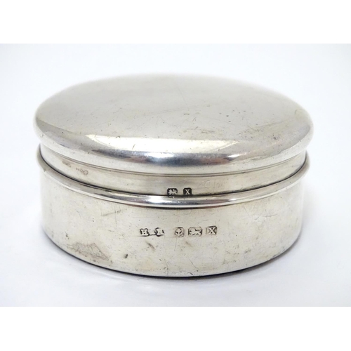 204 - A silver box of circular form. Hallmarked  Birmingham 1922 maker Harrison & Hipwood. 2