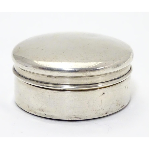 204 - A silver box of circular form. Hallmarked  Birmingham 1922 maker Harrison & Hipwood. 2