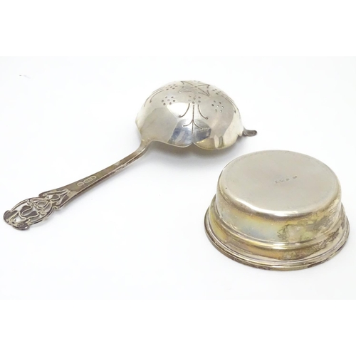 208 - A silver tea strainer and stand. Hallmarked Sheffield 1969.