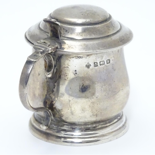 209 - A silver mustard pot on stepped base, with blue glass liner within. Hallmarked Birmingham 1921 maker... 