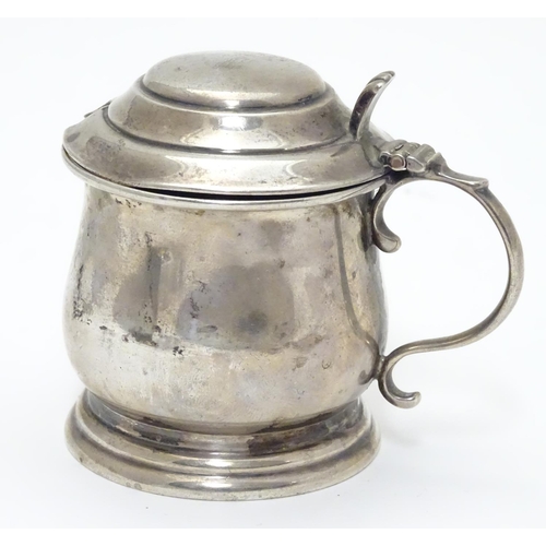 209 - A silver mustard pot on stepped base, with blue glass liner within. Hallmarked Birmingham 1921 maker... 