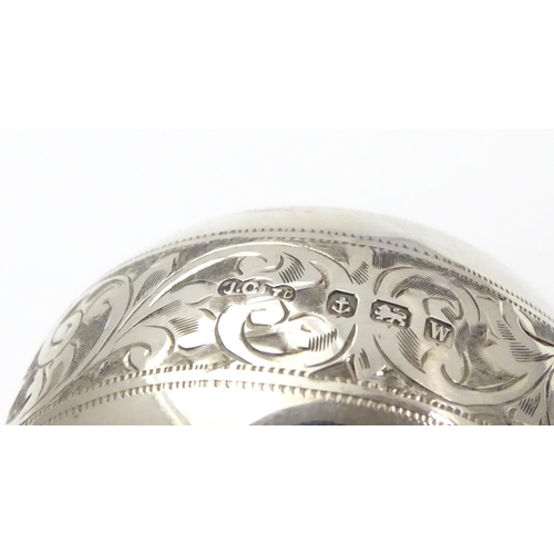 214 - A silver napkin ring with engraved acanthus scroll decoration. Hallmarked Birmingham 1921 maker Jose... 