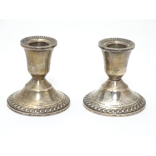 215 - A pair of sterling silver squat candlesticks with weighted bases. Marked Duchin Creation under. Appr... 