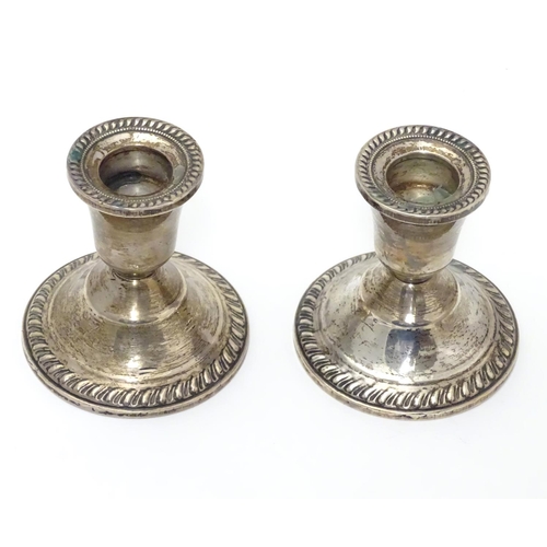 215 - A pair of sterling silver squat candlesticks with weighted bases. Marked Duchin Creation under. Appr... 