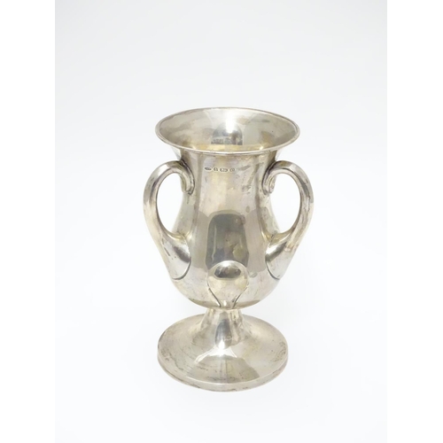 218 - An Art Nouveau silver pedestal  trophy cup with three handles. hallmarked Birmingham 1902 maker Nort... 