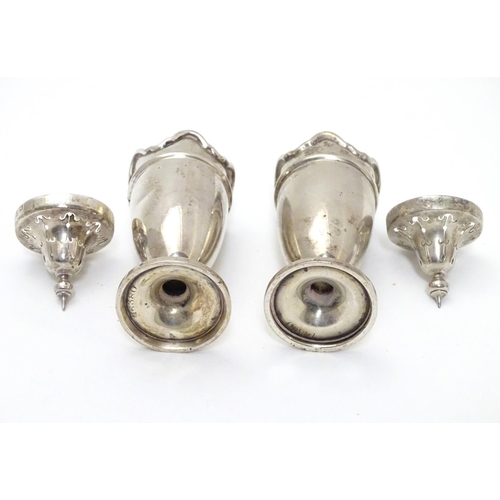 227 - A pair of silver pepperettes with wavy-edged rims. Hallmarked Birmingham 1923 maker Martin Hall & Co... 