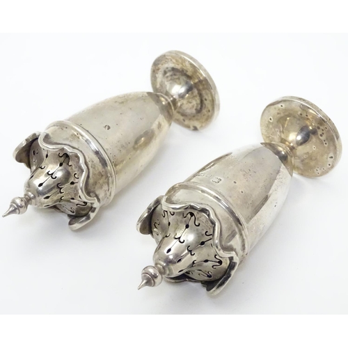 227 - A pair of silver pepperettes with wavy-edged rims. Hallmarked Birmingham 1923 maker Martin Hall & Co... 