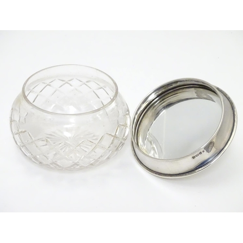 229 - A cut glass powder bowl with silver lid hallmarked Birmingham 1922 maker Charles S Green & Co Ltd. A... 