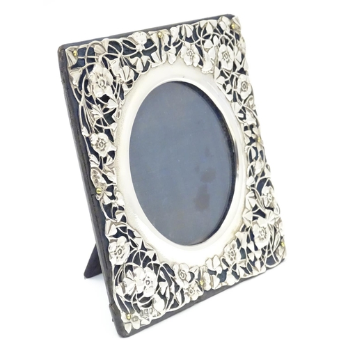 230 - A photograph frame with Art Nouveau silver surround with floral and foliate detail. hallmarked Londo... 