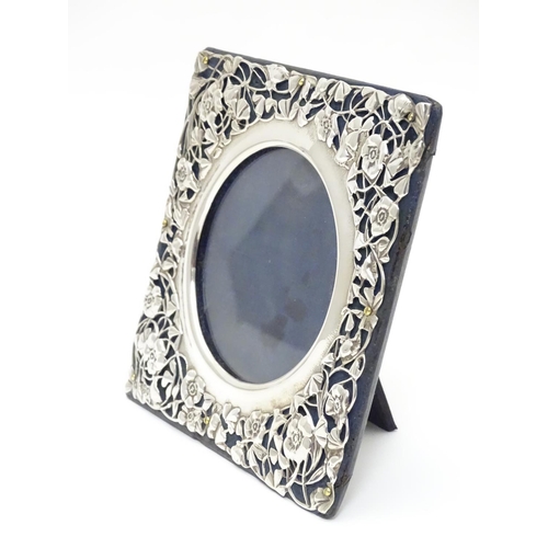 230 - A photograph frame with Art Nouveau silver surround with floral and foliate detail. hallmarked Londo... 