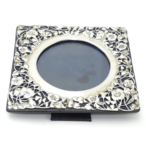 230 - A photograph frame with Art Nouveau silver surround with floral and foliate detail. hallmarked Londo... 