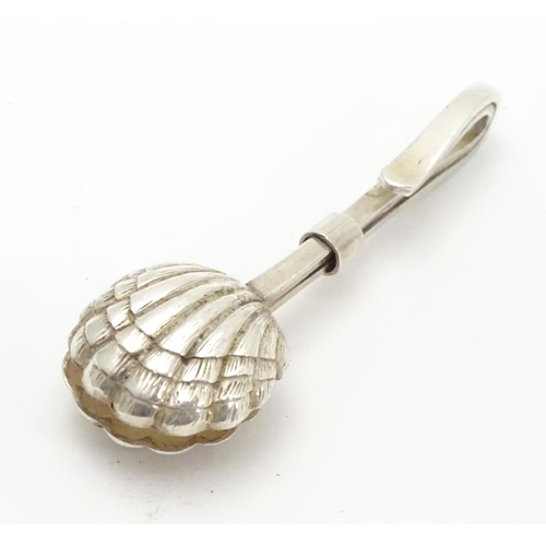 242 - A white metal napkin clip with scallop shell formed grips. 2