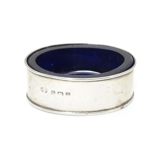 245 - A silver salt of oval form with blue glass liner.  Hallmarked 1919 maker William Aitken.  2 1/4