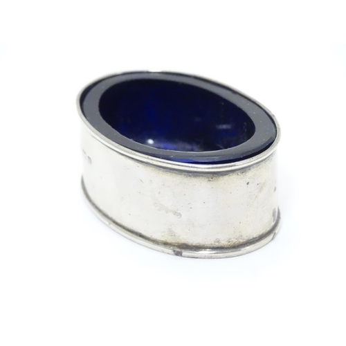 245 - A silver salt of oval form with blue glass liner.  Hallmarked 1919 maker William Aitken.  2 1/4