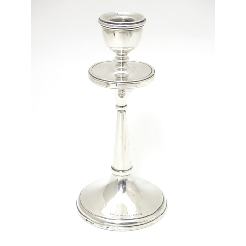 246 - A silver candlestick hallmarked 1918 maker Napper & Davenport and marked with reg des no. 655179. Ap... 