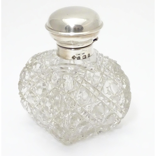 247 - A cut glass scent / perfume bottle with silver top hallmarked Birmingham, 1930  maker William Base &... 