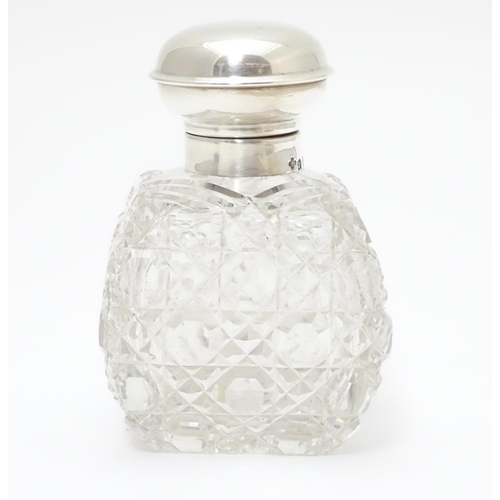 247 - A cut glass scent / perfume bottle with silver top hallmarked Birmingham, 1930  maker William Base &... 