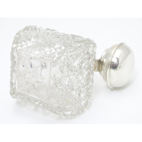 247 - A cut glass scent / perfume bottle with silver top hallmarked Birmingham, 1930  maker William Base &... 