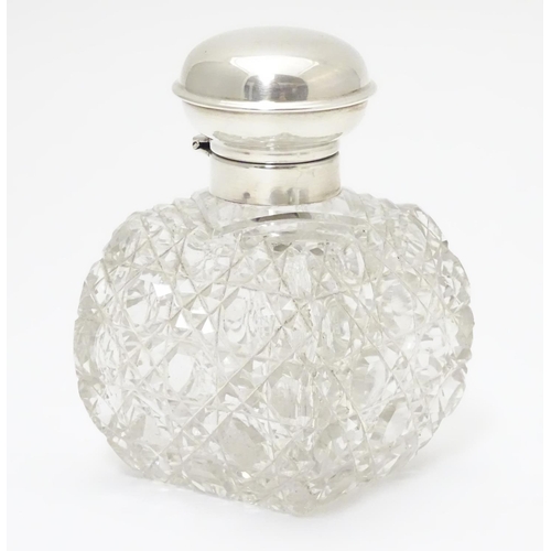 247 - A cut glass scent / perfume bottle with silver top hallmarked Birmingham, 1930  maker William Base &... 