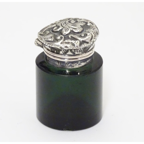 251 - A Victorian green glass scent / salts bottle with silver mount and lid, Birmingham 1898  Approx 1 1/... 