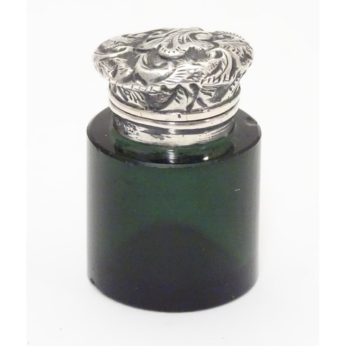 251 - A Victorian green glass scent / salts bottle with silver mount and lid, Birmingham 1898  Approx 1 1/... 