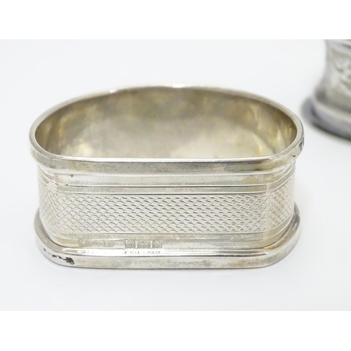 255 - Two silver napkin rings, one D-shaped with engine-turned decoration, hallmarked Birmingham 1965 make... 