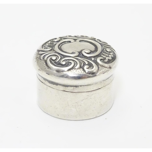 258 - A small silver box of circular form with embossed decoration to lid. Hallmarked Birmingham 1902 make... 