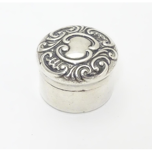 258 - A small silver box of circular form with embossed decoration to lid. Hallmarked Birmingham 1902 make... 