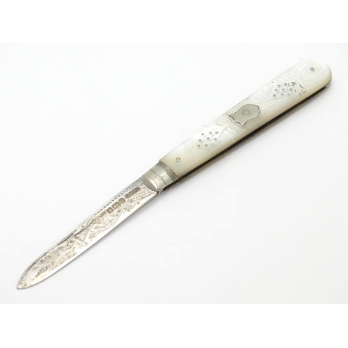 273 - A silver folding fruit knife with mother of pearl handle having engraved decoration.  Hallmarked She... 