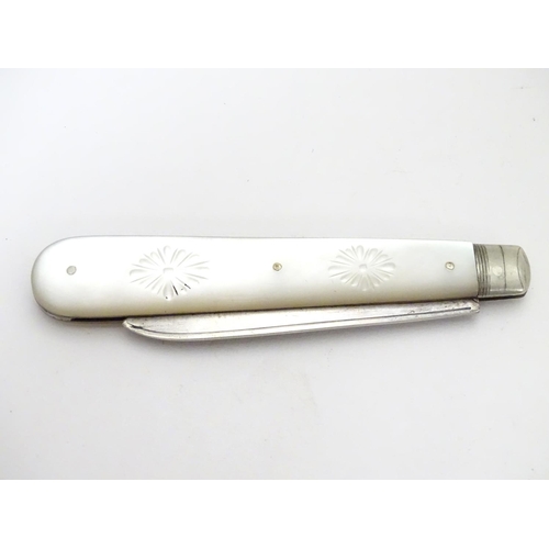 273 - A silver folding fruit knife with mother of pearl handle having engraved decoration.  Hallmarked She... 