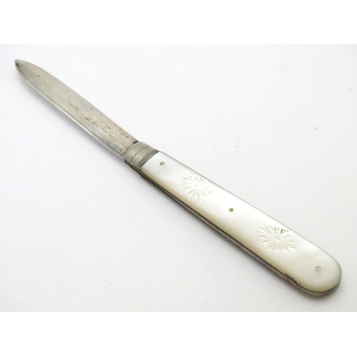 273 - A silver folding fruit knife with mother of pearl handle having engraved decoration.  Hallmarked She... 