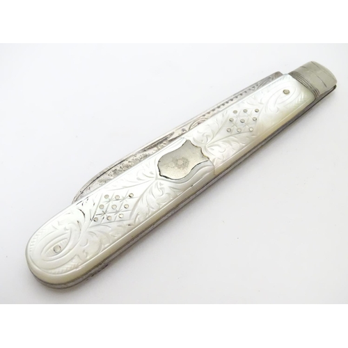 273 - A silver folding fruit knife with mother of pearl handle having engraved decoration.  Hallmarked She... 