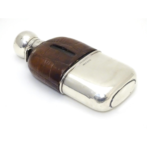 279 - A Victorian glass hip flask with half leather covering, silver beaker lower and silver mounts. Hallm... 