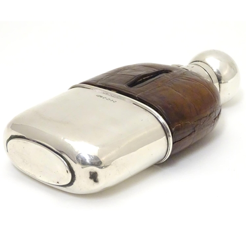 279 - A Victorian glass hip flask with half leather covering, silver beaker lower and silver mounts. Hallm... 